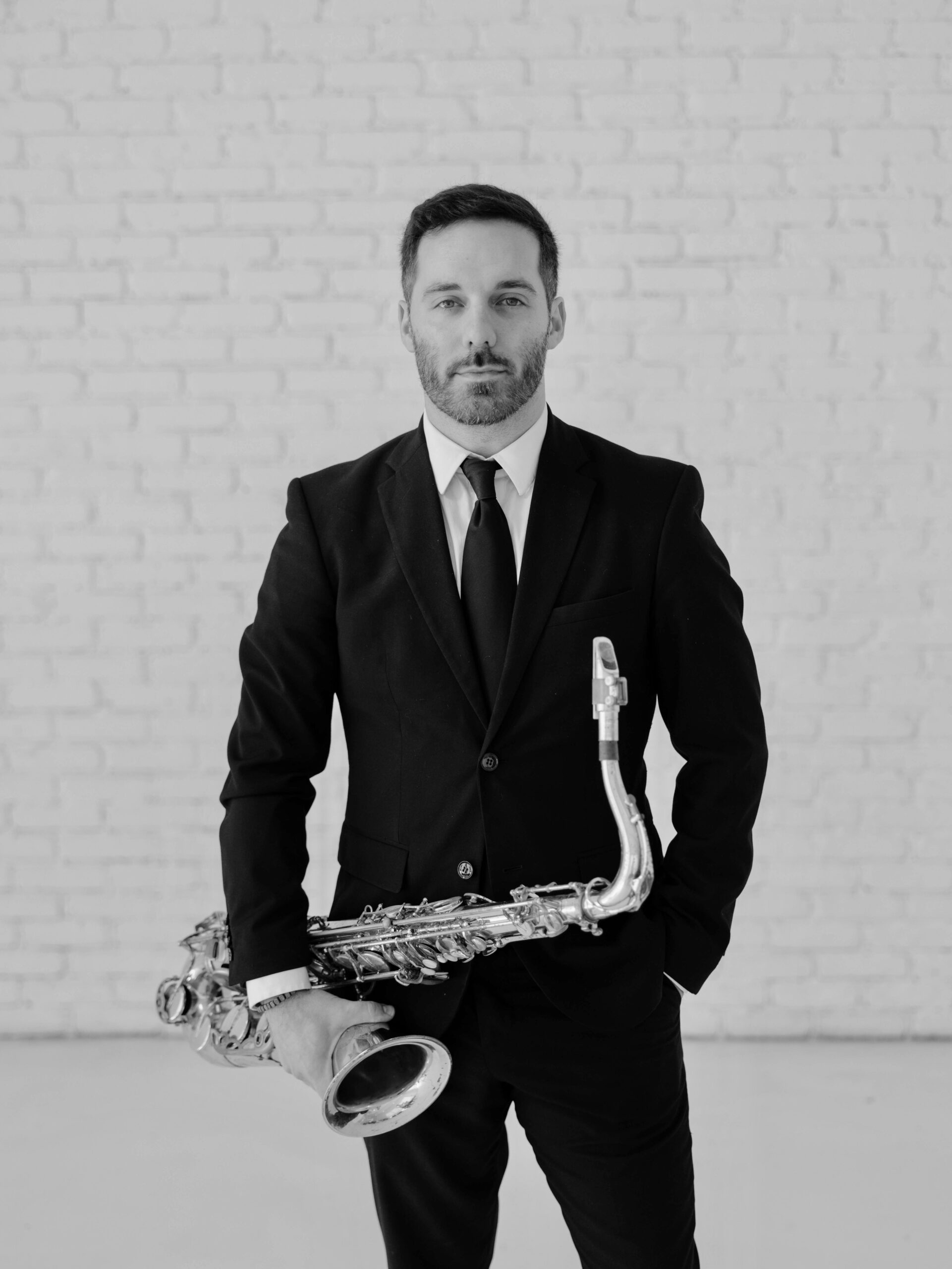 Evan holding his saxophone